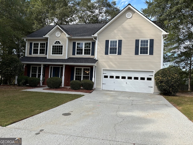 front facade featuring a front yard and a garage