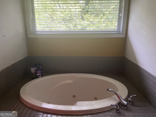 bathroom with tiled bath and a wealth of natural light