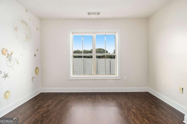 empty room featuring dark wood-type flooring