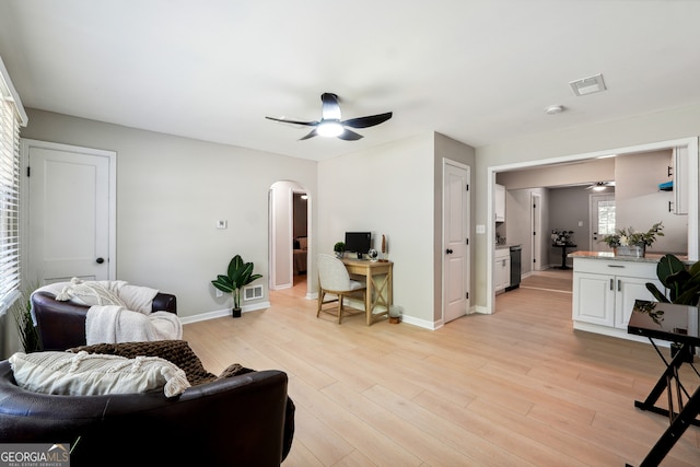 living room with ceiling fan and light hardwood / wood-style flooring