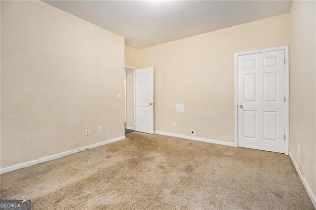 unfurnished room featuring carpet