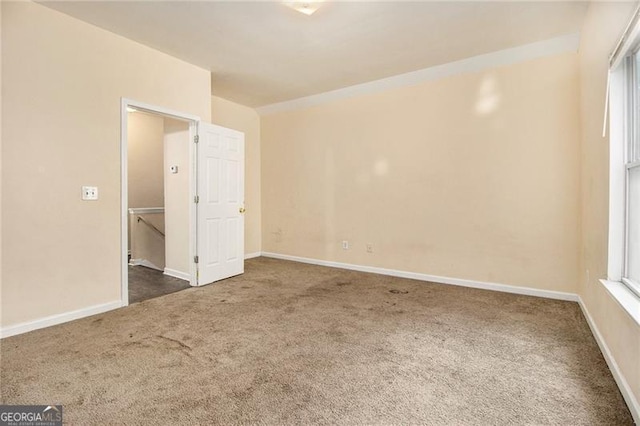 carpeted spare room featuring a healthy amount of sunlight