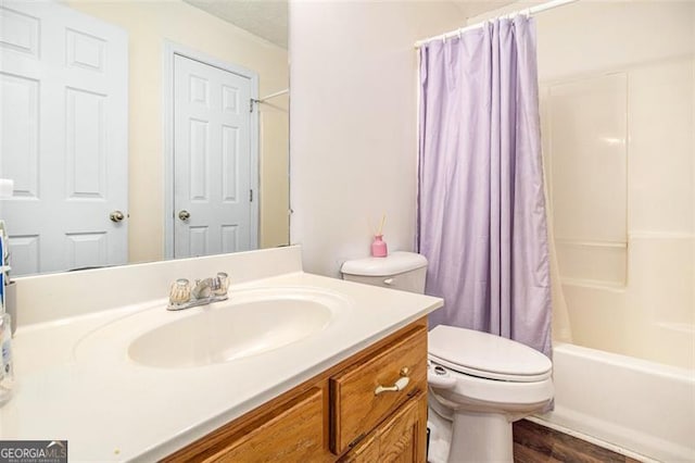 full bathroom featuring toilet, wood finished floors, shower / bath combination with curtain, and vanity