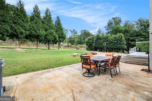 view of patio featuring outdoor dining area and fence