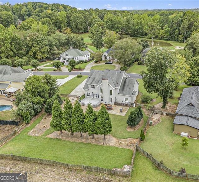 rear view of house with a lawn, a patio area, and a fire pit