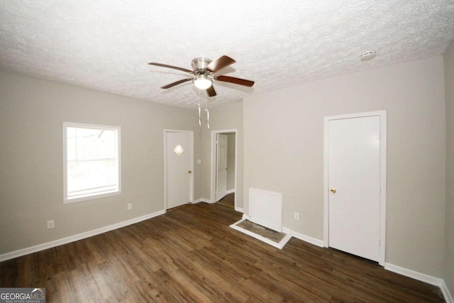 spare room featuring ceiling fan, a textured ceiling, and dark hardwood / wood-style flooring