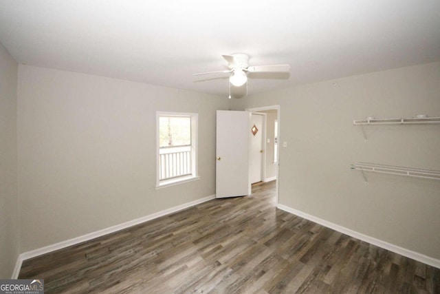 empty room with ceiling fan and dark hardwood / wood-style floors