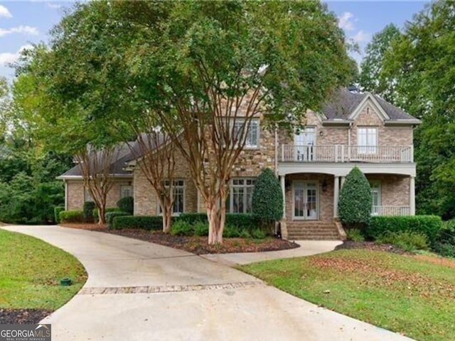 view of front of house with a balcony and covered porch