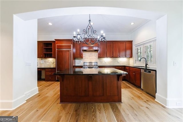 kitchen with light hardwood / wood-style floors, sink, premium range hood, and stainless steel appliances