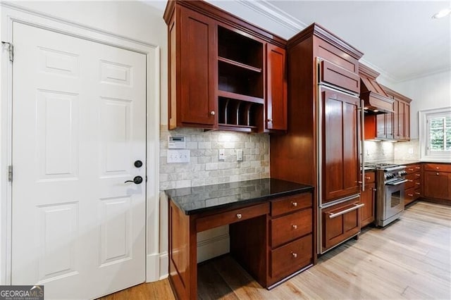 kitchen featuring premium range hood, tasteful backsplash, ornamental molding, high end appliances, and light hardwood / wood-style flooring