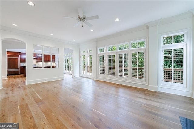 unfurnished living room with light hardwood / wood-style flooring, ceiling fan, and crown molding