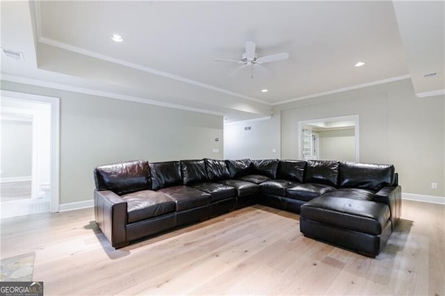 living room with ceiling fan, crown molding, and light hardwood / wood-style flooring