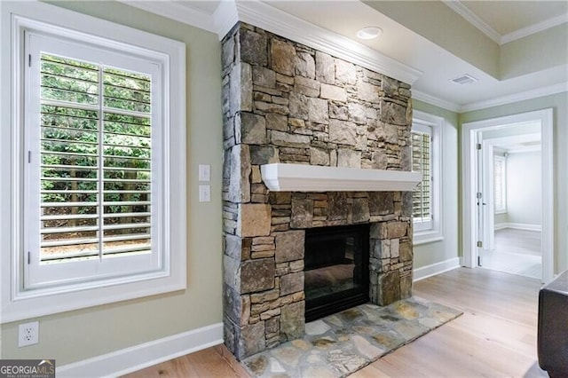 living room featuring a fireplace, hardwood / wood-style flooring, and ornamental molding