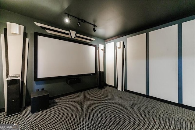 carpeted home theater room with track lighting