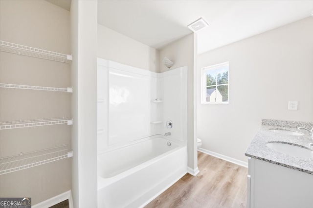 full bathroom with vanity, shower / bathing tub combination, hardwood / wood-style flooring, and toilet