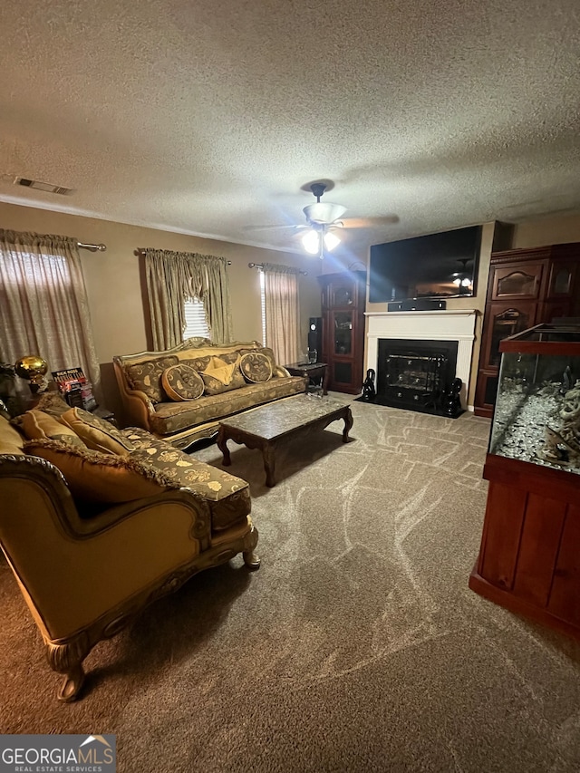 carpeted living room with a textured ceiling and ceiling fan