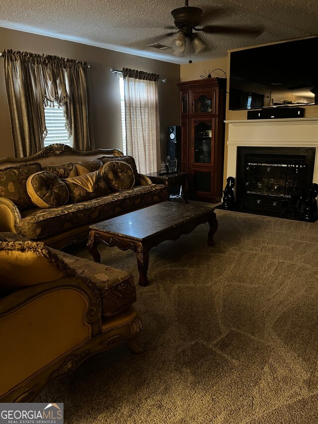 carpeted living room featuring a textured ceiling and ceiling fan