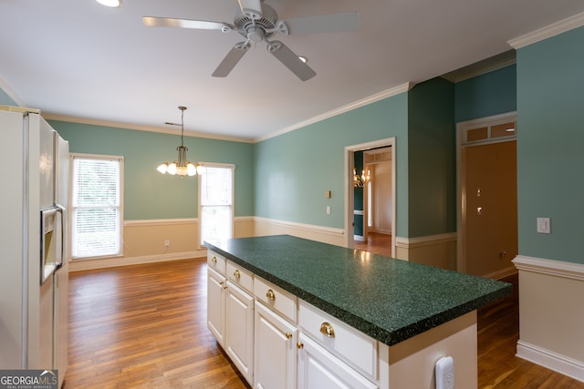 kitchen with white refrigerator with ice dispenser, dark hardwood / wood-style floors, white cabinets, and a kitchen island