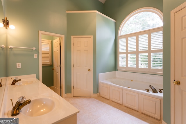 bathroom with vanity, tile patterned floors, and a bathtub