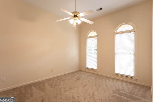 carpeted spare room with ceiling fan