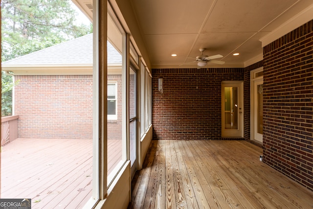 unfurnished sunroom with a healthy amount of sunlight and ceiling fan