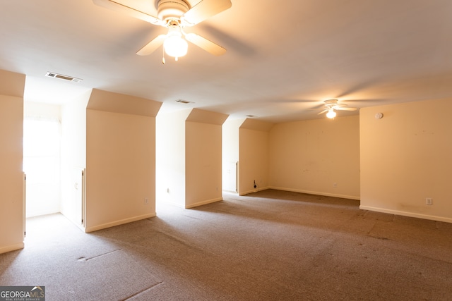 interior space with ceiling fan and light carpet