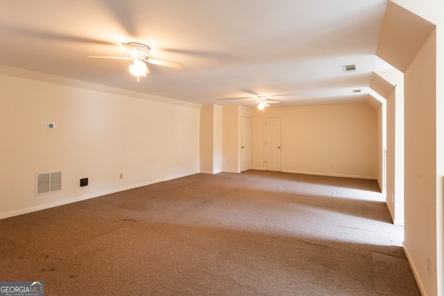 carpeted spare room featuring ceiling fan and lofted ceiling