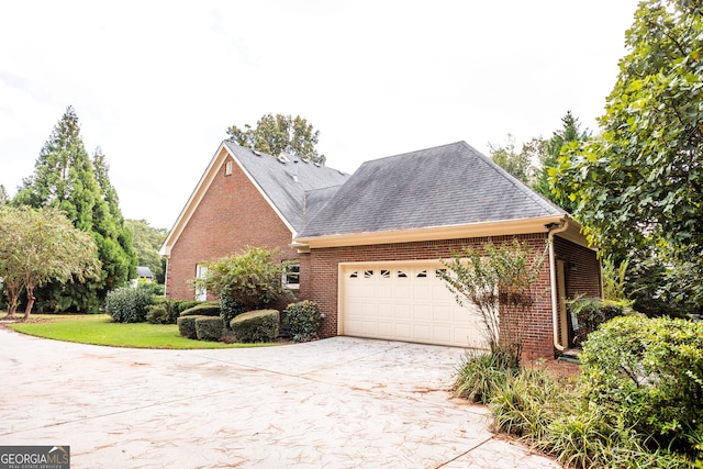 view of property exterior featuring a garage and a lawn