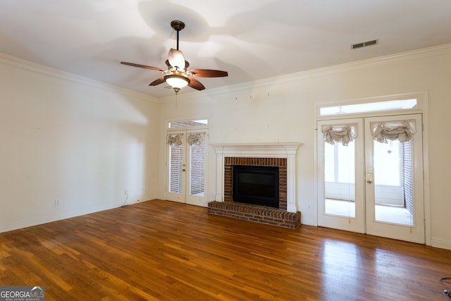 unfurnished living room with french doors, crown molding, hardwood / wood-style floors, and ceiling fan