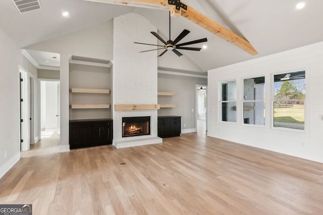 unfurnished living room with ceiling fan, a healthy amount of sunlight, a fireplace, and light wood-type flooring