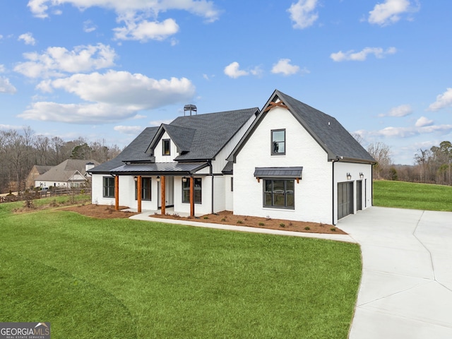 view of front of home featuring a garage, covered porch, and a front lawn