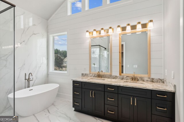 bathroom featuring lofted ceiling, separate shower and tub, and vanity