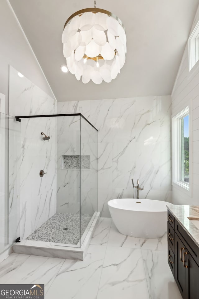 bathroom featuring lofted ceiling, vanity, independent shower and bath, and a chandelier