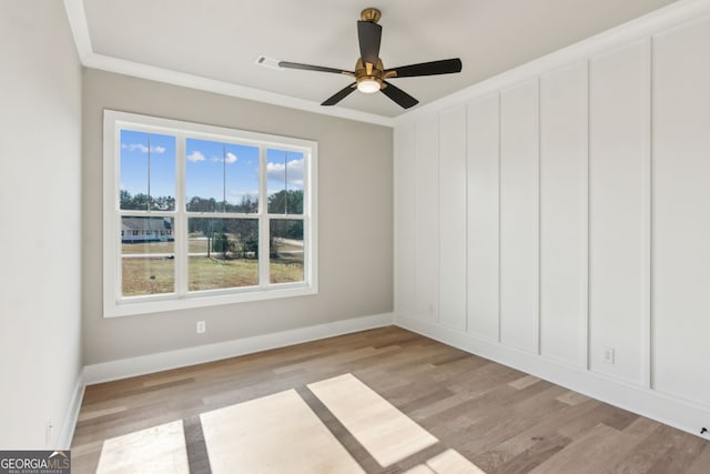 unfurnished room with crown molding, ceiling fan, and light wood-type flooring