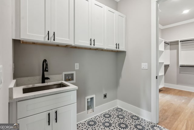 washroom featuring sink, crown molding, cabinets, hookup for a washing machine, and hookup for an electric dryer