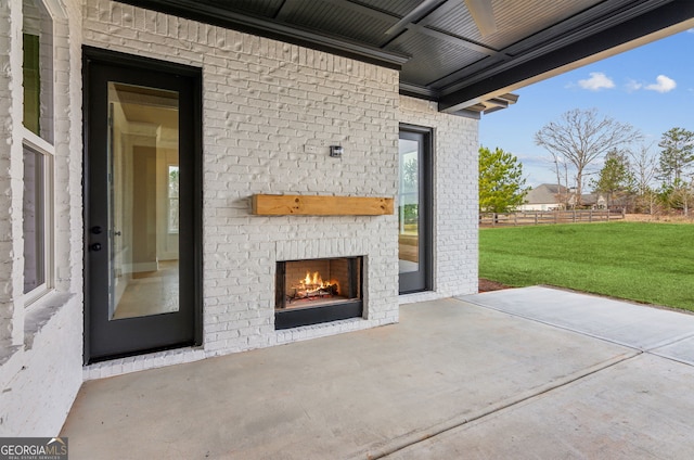 view of patio / terrace with an outdoor brick fireplace