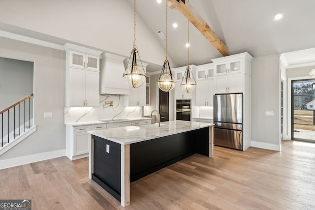 kitchen with stainless steel appliances, decorative light fixtures, and white cabinets