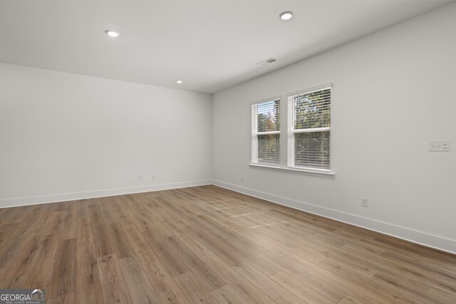 unfurnished room with light wood-type flooring