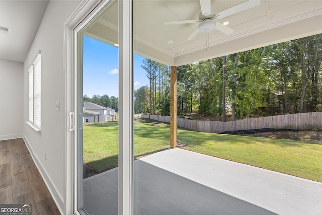 unfurnished sunroom featuring ceiling fan