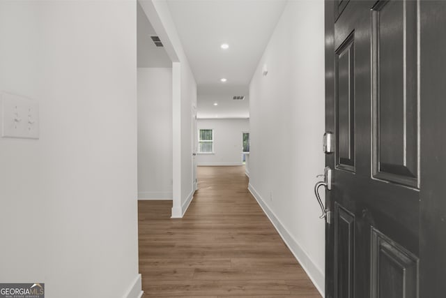 corridor with wood-type flooring