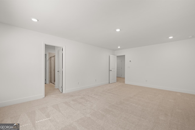 unfurnished room with light carpet