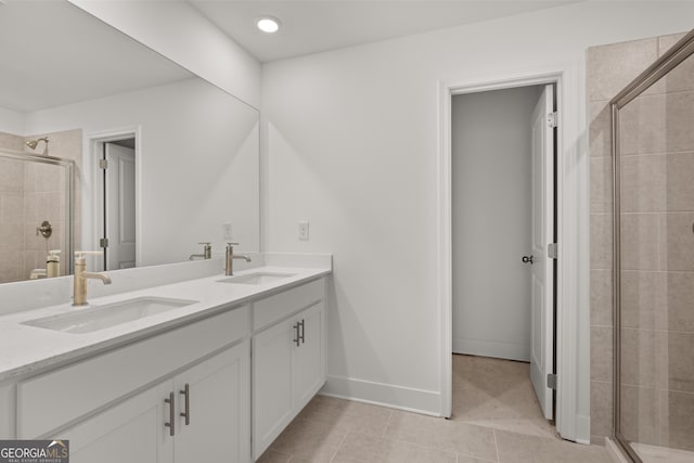 bathroom featuring tile patterned flooring, walk in shower, and vanity