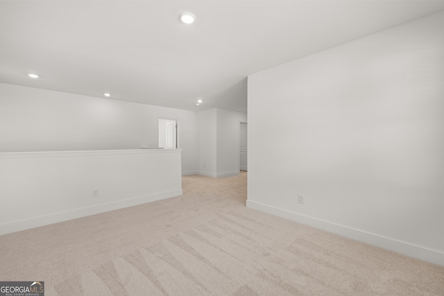 unfurnished room with light colored carpet