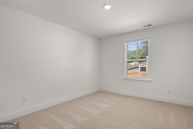 spare room with light colored carpet