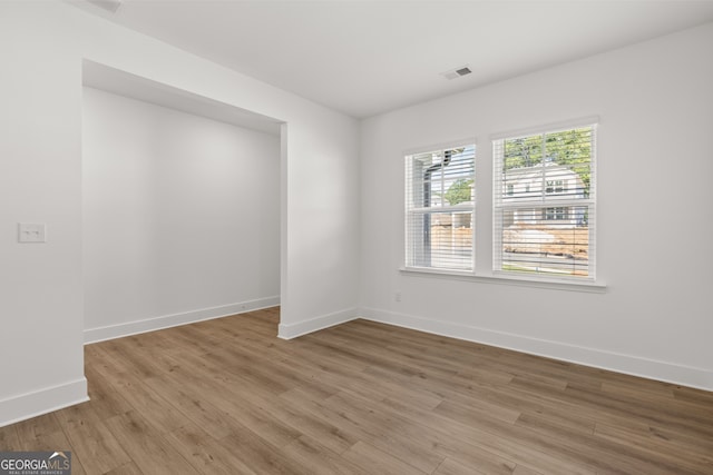 unfurnished room with light hardwood / wood-style floors