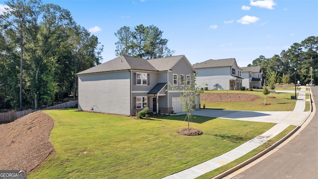 view of front facade featuring a garage and a front lawn