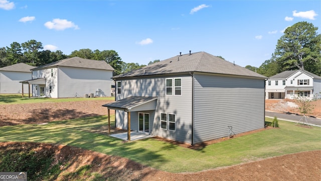 back of property featuring a patio area and a yard