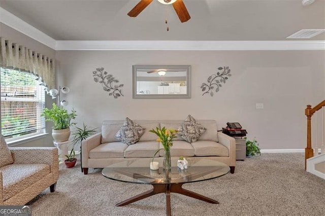 living room with ceiling fan, crown molding, and carpet