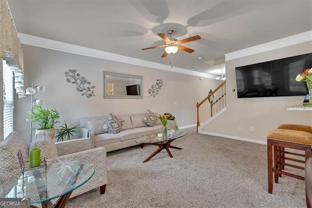 carpeted living room featuring ornamental molding and ceiling fan