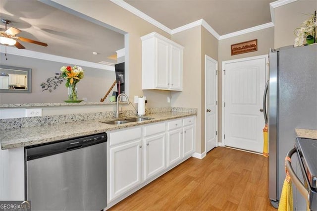 kitchen featuring light hardwood / wood-style floors, white cabinetry, stainless steel appliances, ornamental molding, and sink